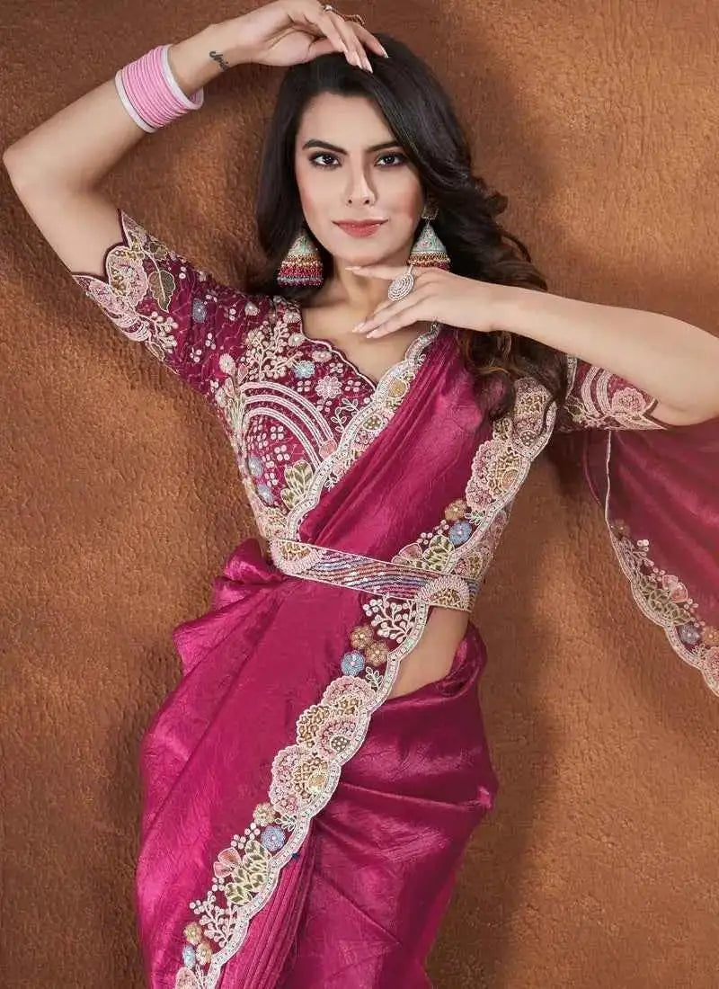 Rose pink silk saree with wide gold-cream embroidered border and patterned blouse