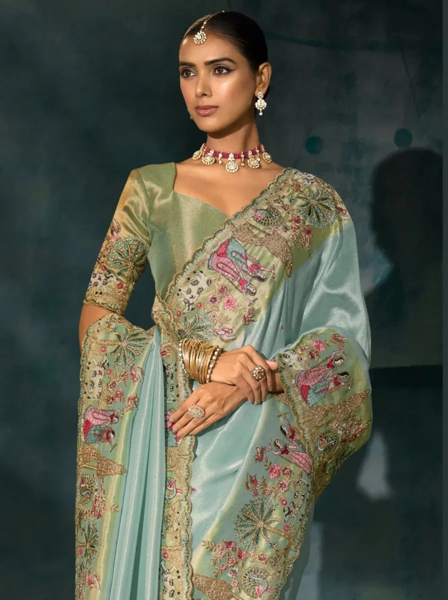 Aqua blue saree with ornate gold-toned border and embroidered floral motifs