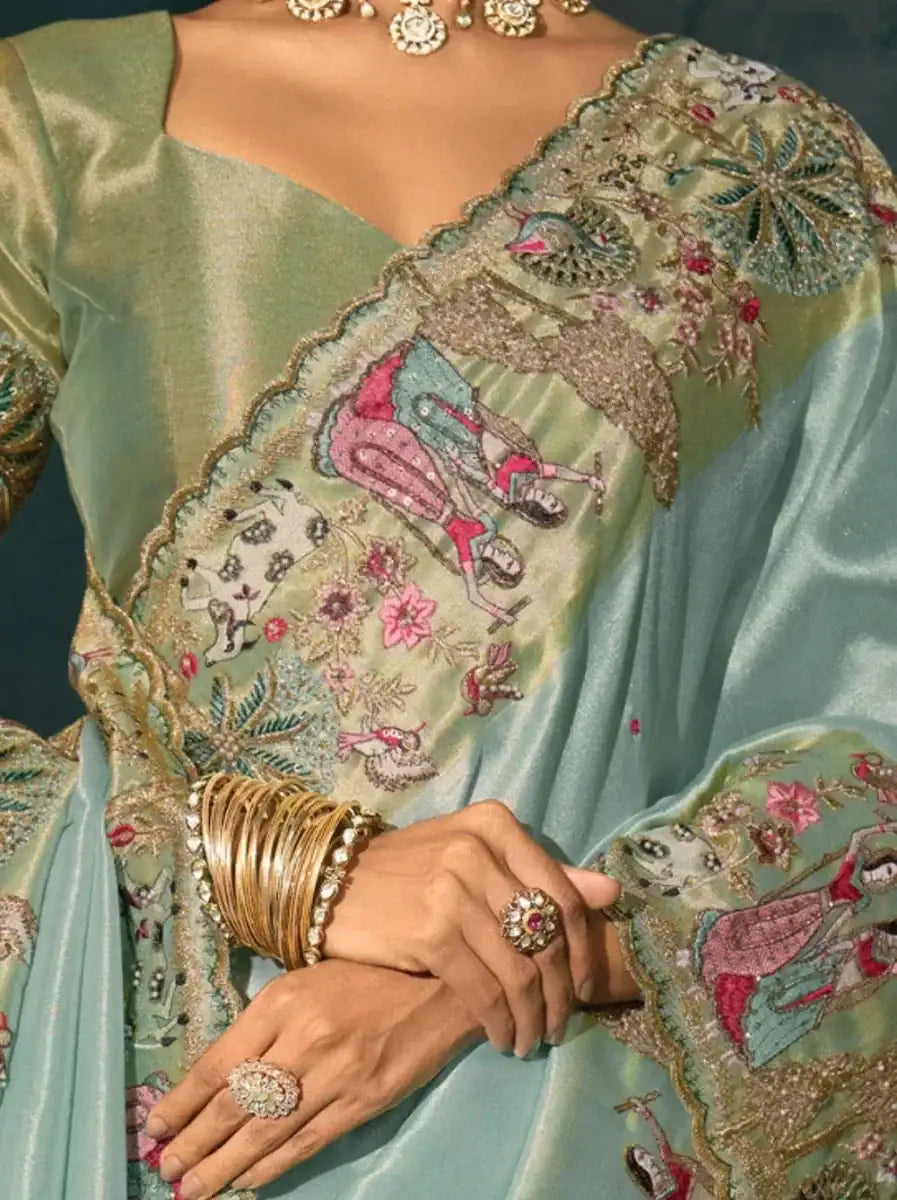 Aqua blue saree close-up of embroidered pallu border with pink accents and beadwork