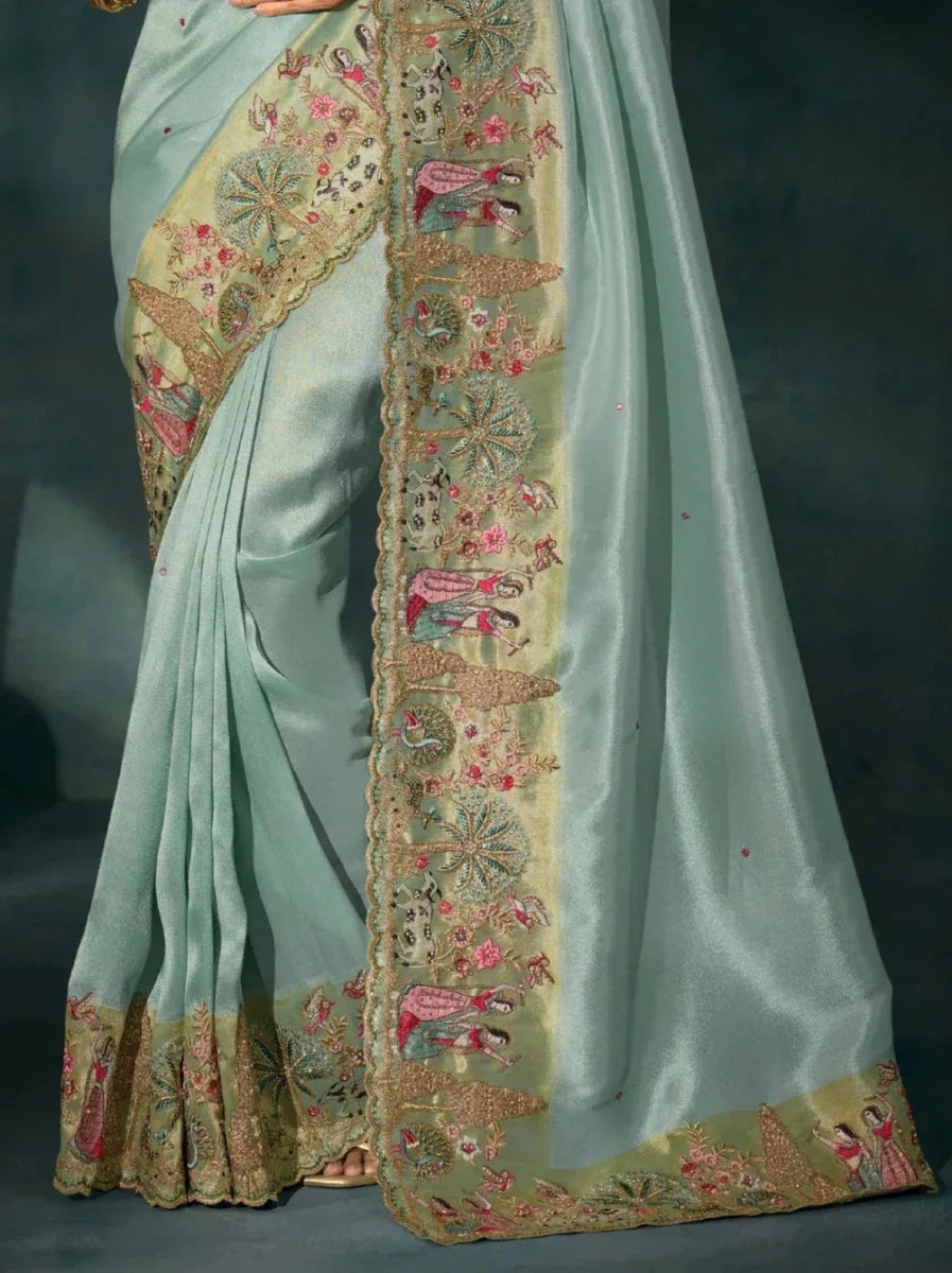 Aqua blue saree close-up of gold border with embroidered floral and paisley motifs