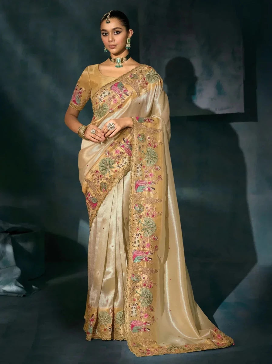 Golden cream Banarasi heritage saree with peacock and floral embroidery, standing pose