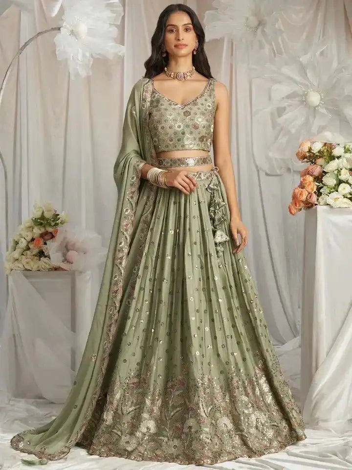 Sage green embroidered lehenga with sleeveless blouse, metallic border and dupatta