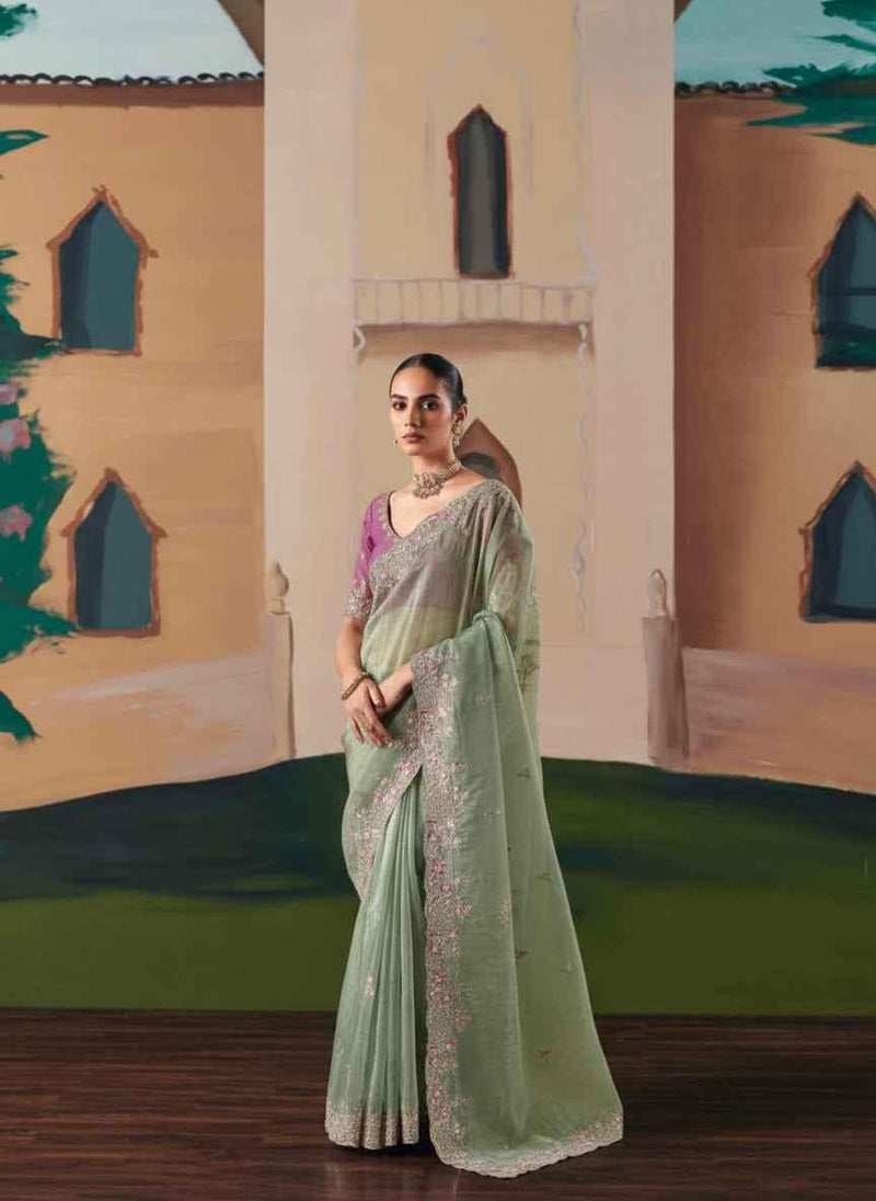Sage green organza saree with sequin and stonework detailing on sheer drape and border