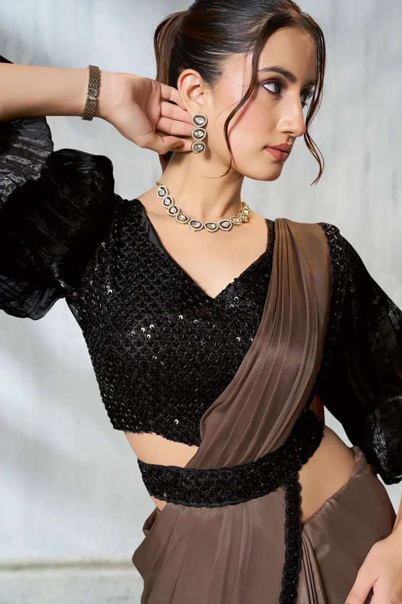 Ruffle saree close-up: black sequined V-neck blouse with taupe drape and trim