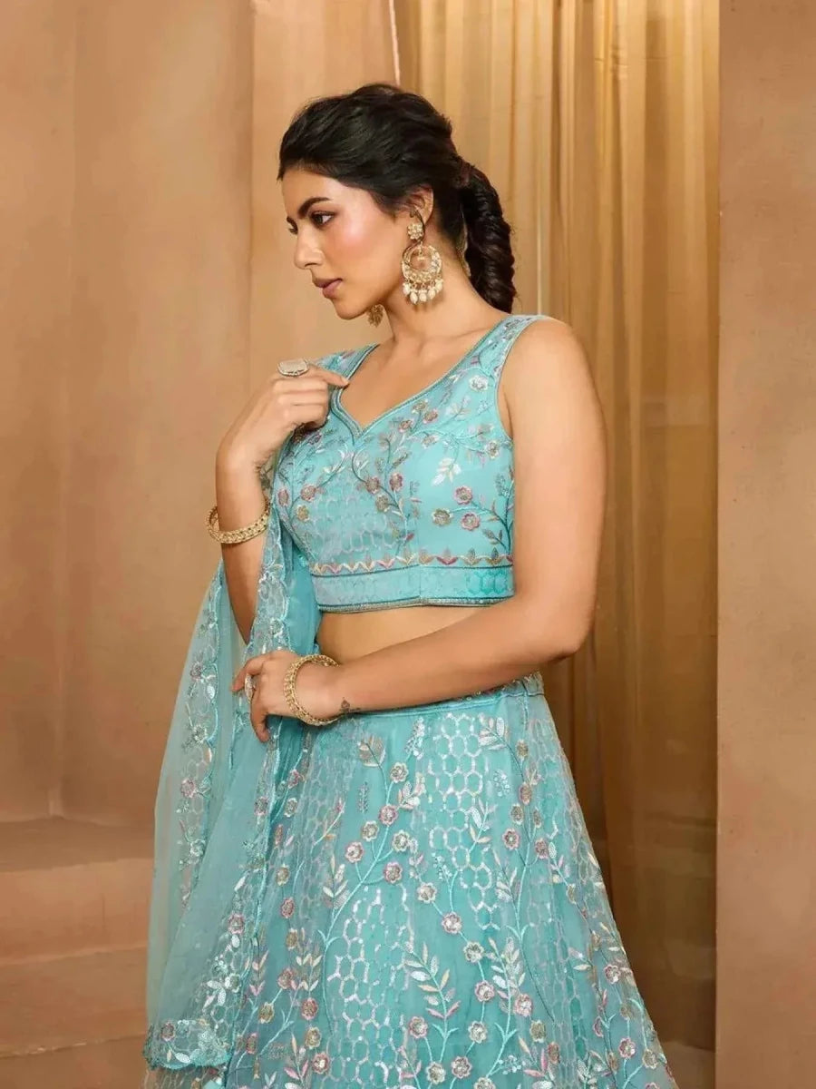 Sea green net lehenga with floral embroidery, sleeveless blouse and fitted waist
