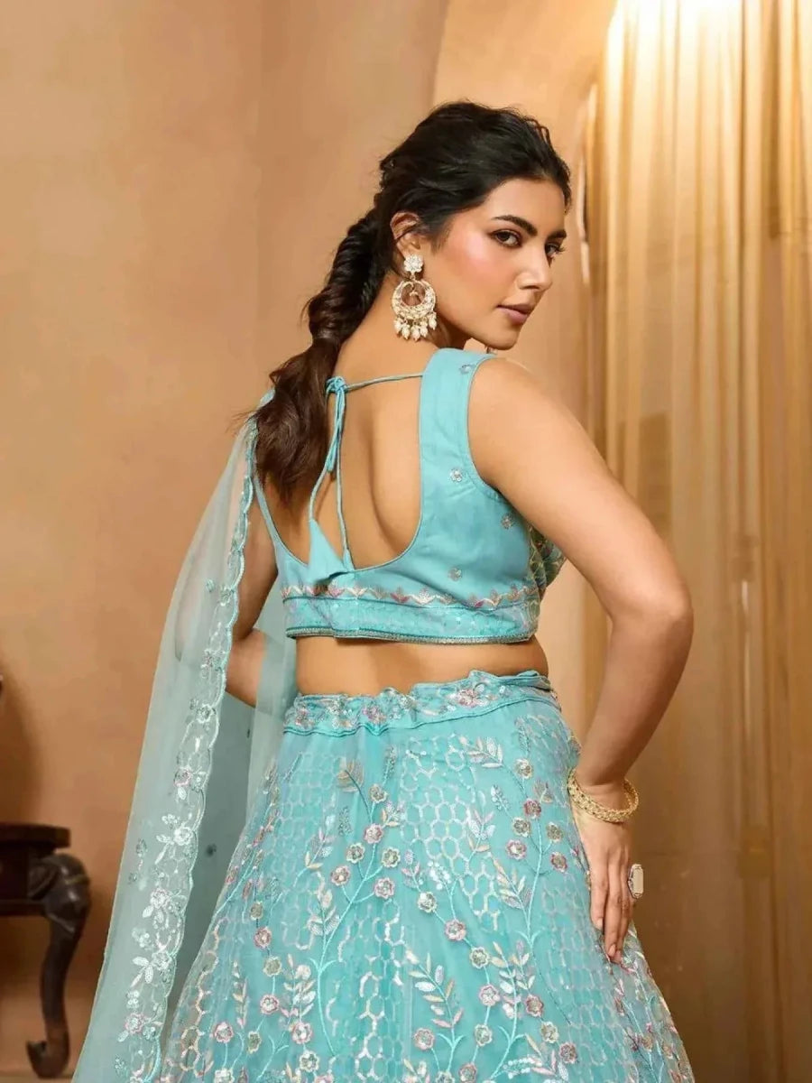 Sea green net lehenga with floral embroidery, open-back sleeveless blouse and dupatta