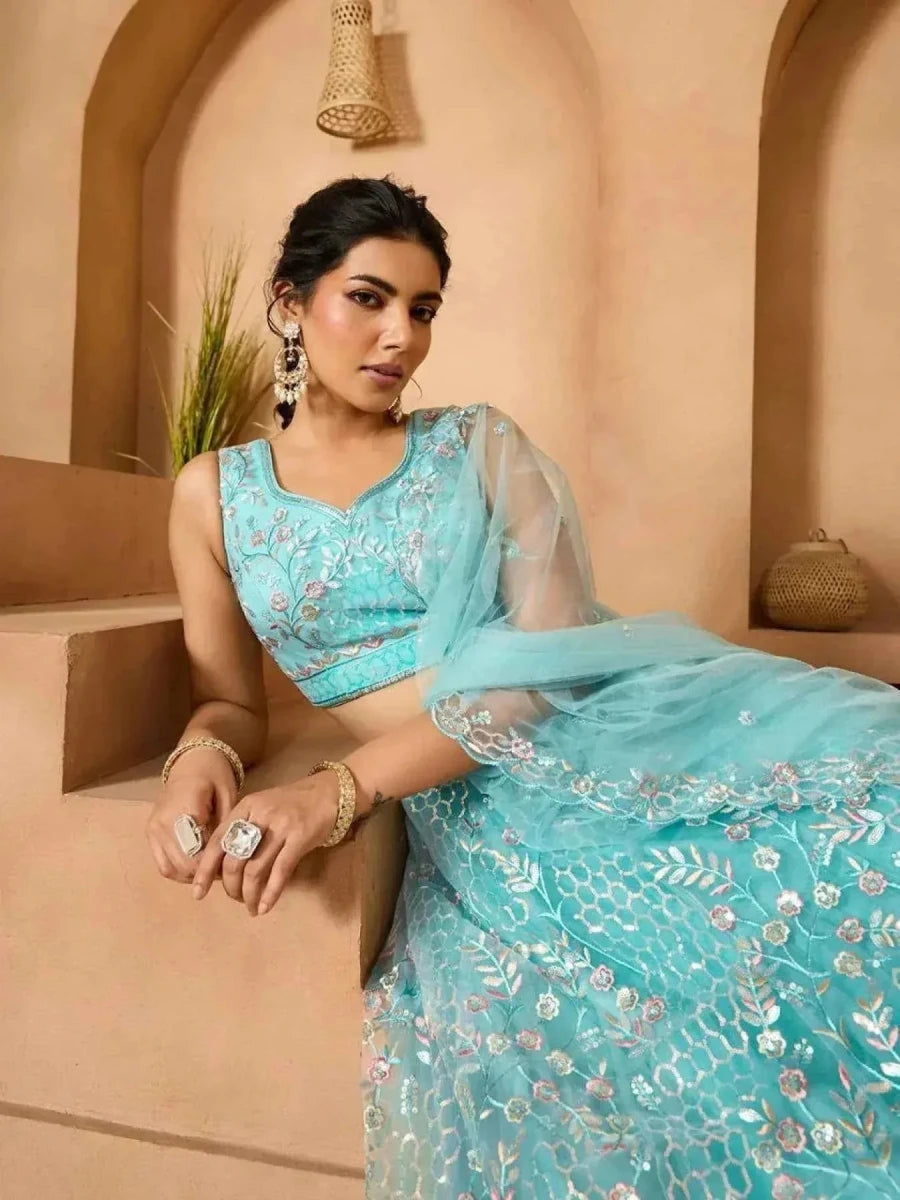 Sea green net lehenga with floral embroidery, sleeveless blouse and flowing dupatta