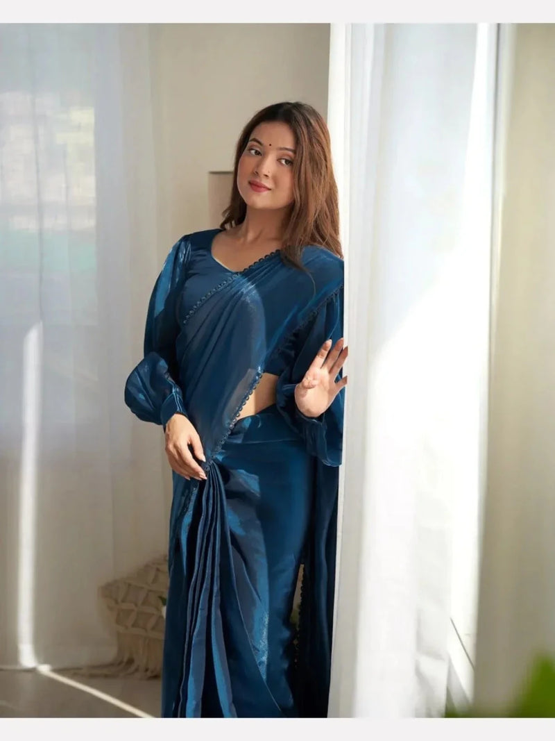 Petroleum teal shimmer saree with long sleeves, beaded neckline, and side drape