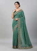 Teal green shimmer saree with gold-toned floral embroidery and embellished border