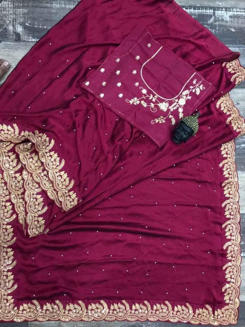 Wine silk saree detail with dotted sequin work and ornate gold zari border