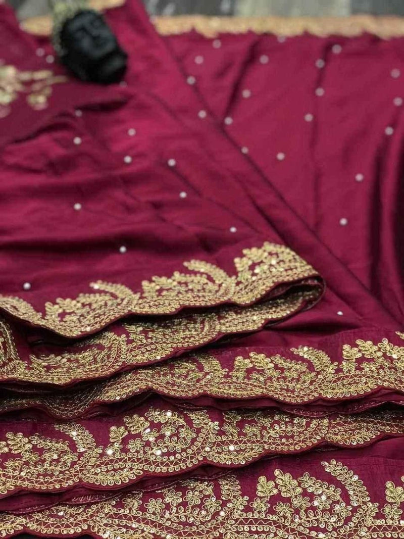 Wine silk saree hem with wide gold zari cutwork border and scattered sequins