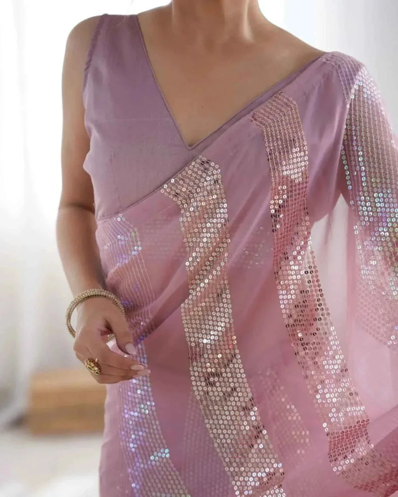 Pastel pink georgette saree close-up with dense linear sequin embroidery on pallu
