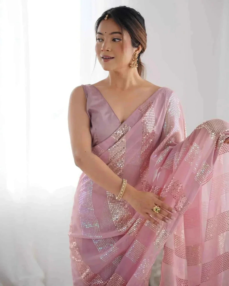 Pastel pink georgette saree showing pallu and linear sequined panel details