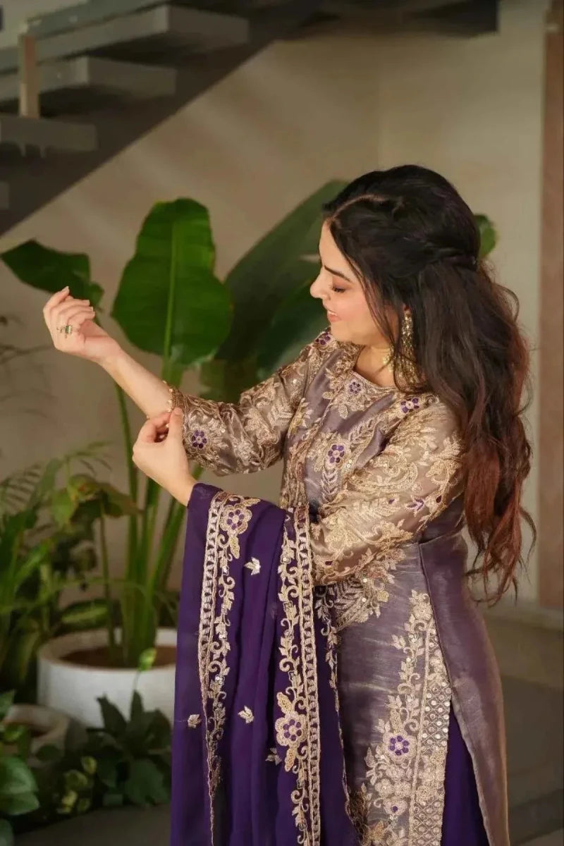 Close view of embroidered tunic and purple dupatta border over a purple flared skirt
