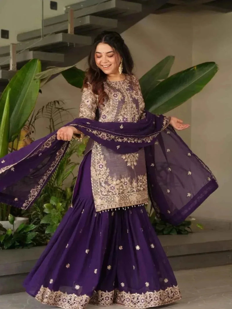Purple embroidered sharara suit with gold-toned tunic, flared skirt, and embellished dupatta