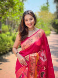 Smiling woman in rani pink Paithani silk saree with zari floral border standing outdoors