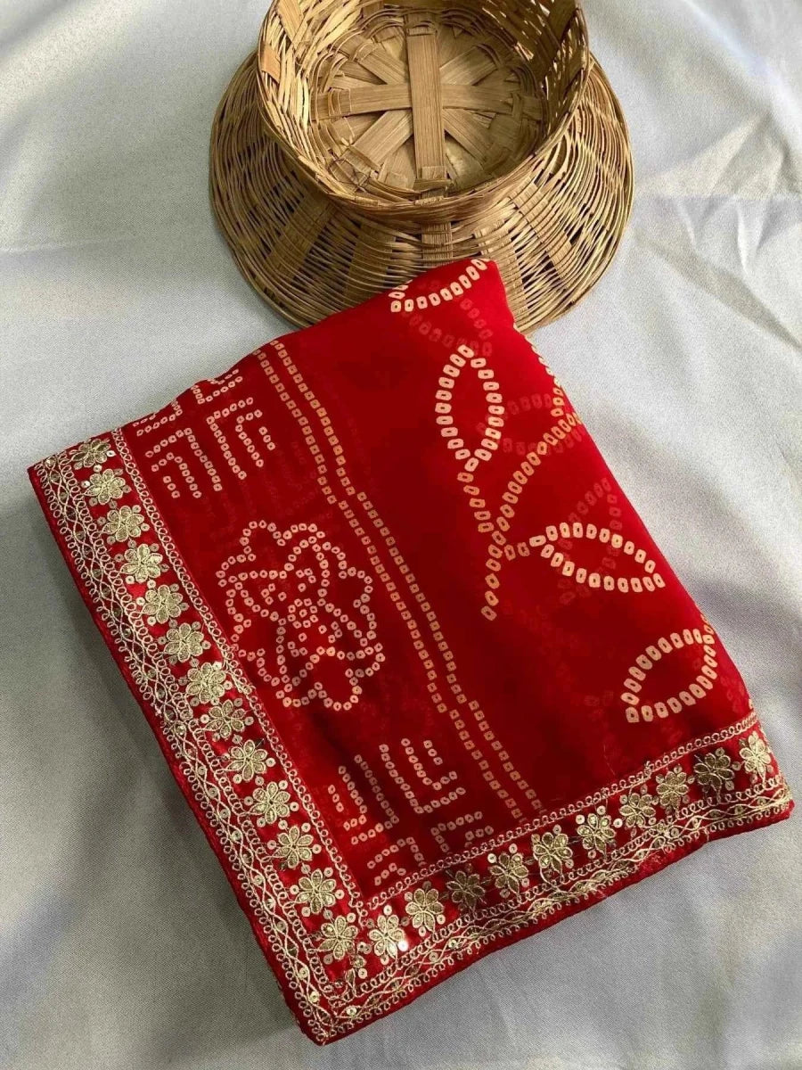 Red georgette bandhani saree folded, embroidered border with gold motif detailing
