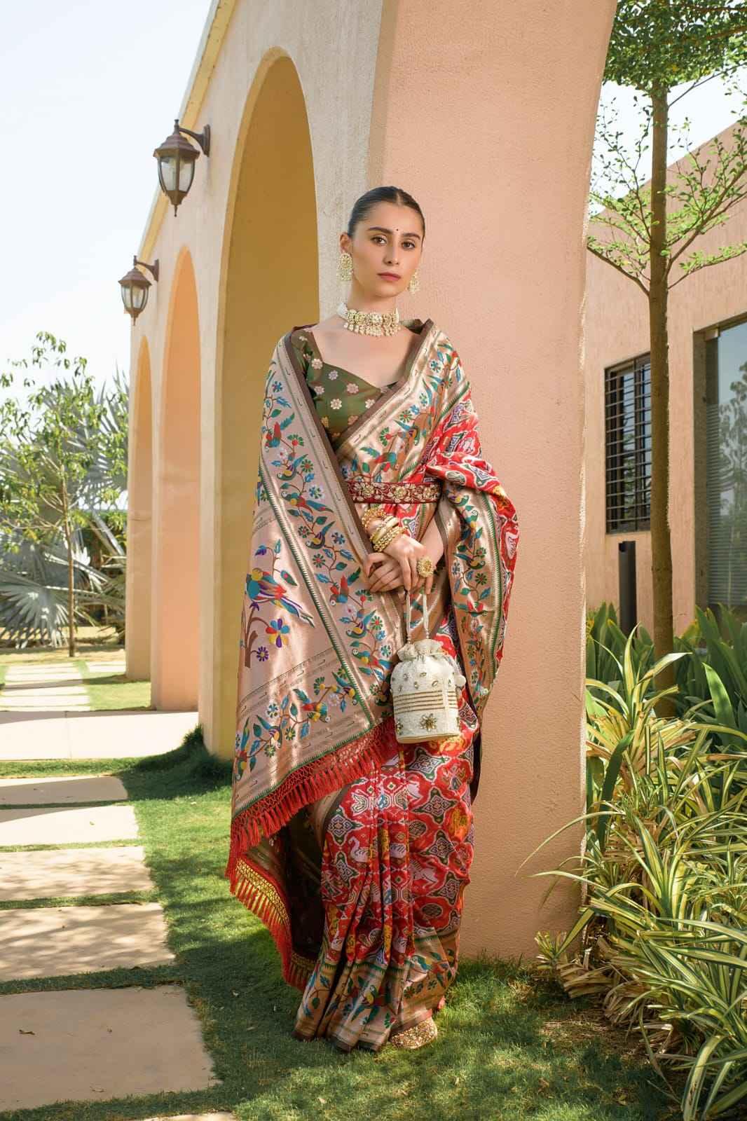 Woman in elegant red Paithani silk saree with intricate zari weaving, floral motifs, and traditional jewelry