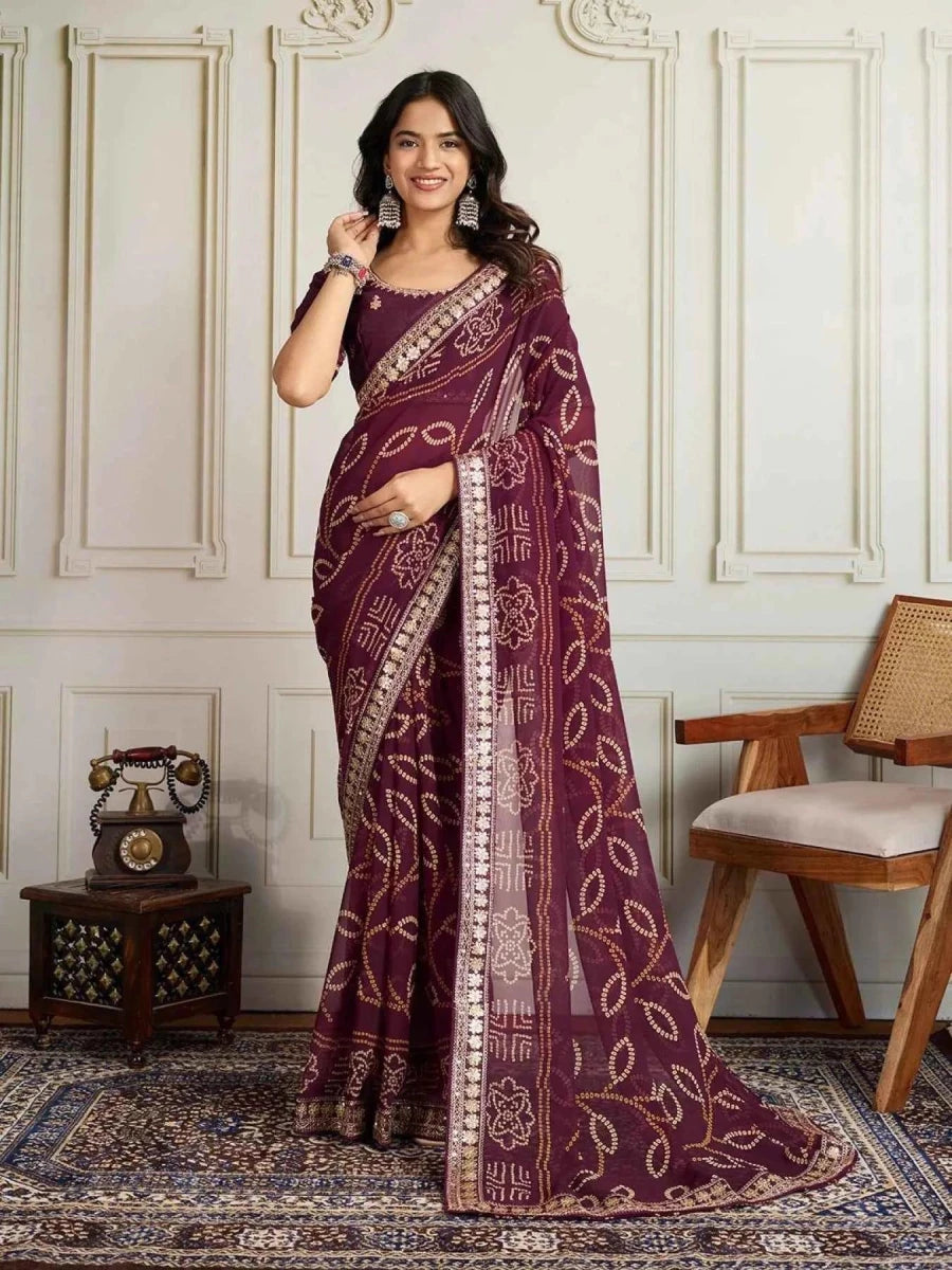 Wine bandhani saree with embroidered border and patterned pallu drape
