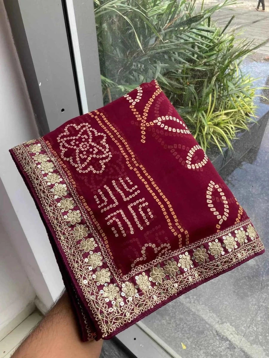 Wine bandhani saree fabric with ornate gold embroidered border and corner motifs