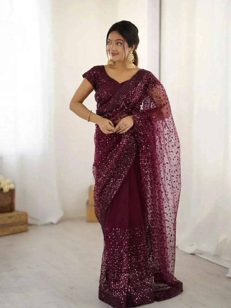 Burgundy sequin saree with V-neck short-sleeve blouse and net pallu, standing