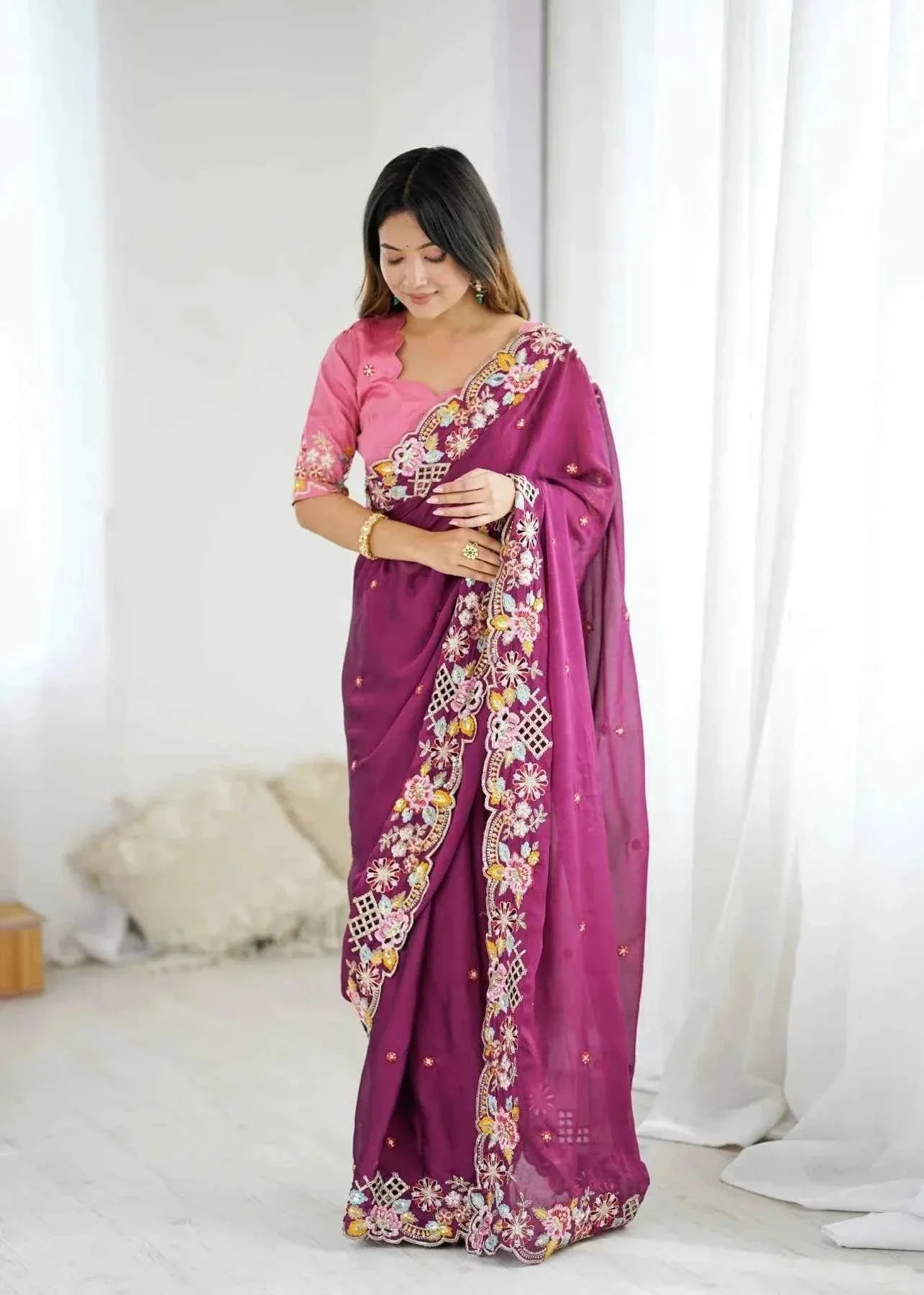 Woman wearing wine noha crush saree with sequin cutwork embroidery in bright indoor setting